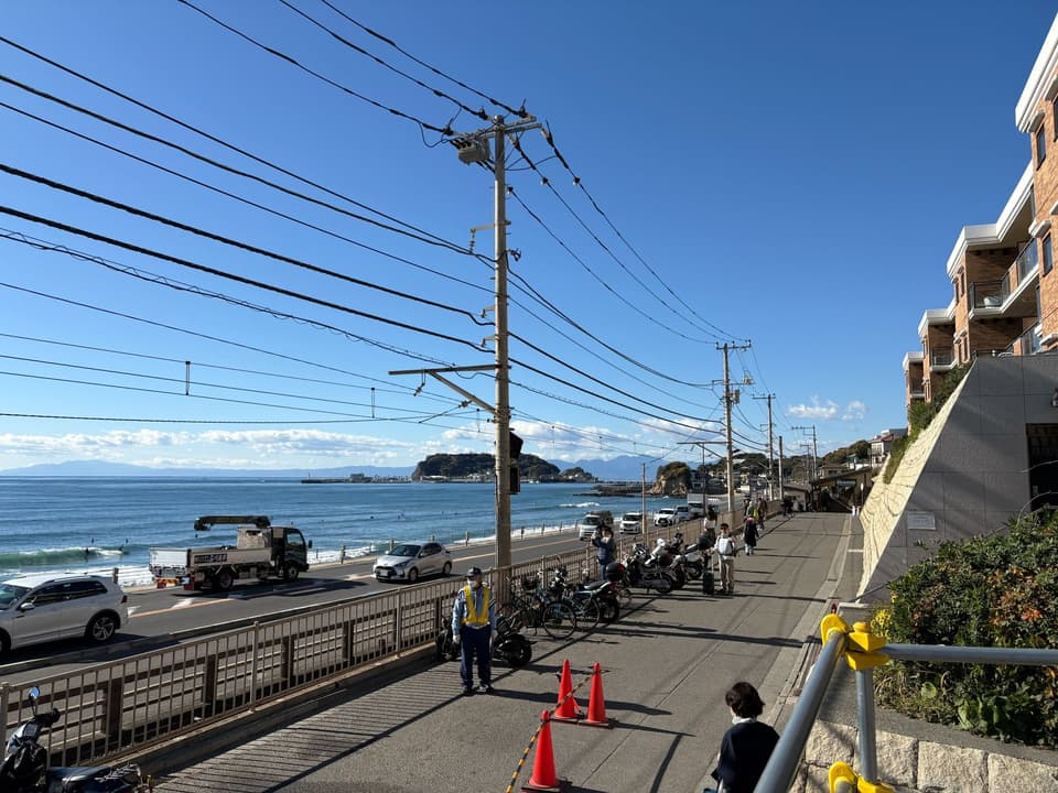 Scenic coastal road near Enoshima Island, with clear blue sky and ocean view in Japan.