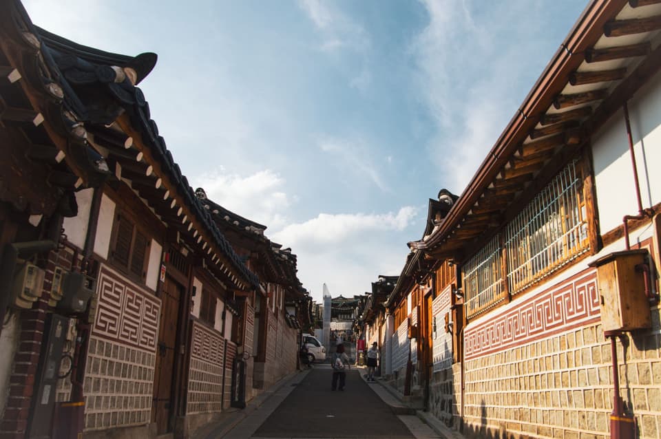 Scenic view of traditional Hanok Village street in Seoul, South Korea, under clear skies.
