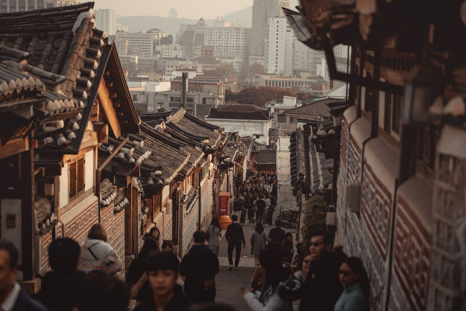 Explore Bukchon Hanok Village in Seoul, showcasing traditional Korean architecture and bustling streets.