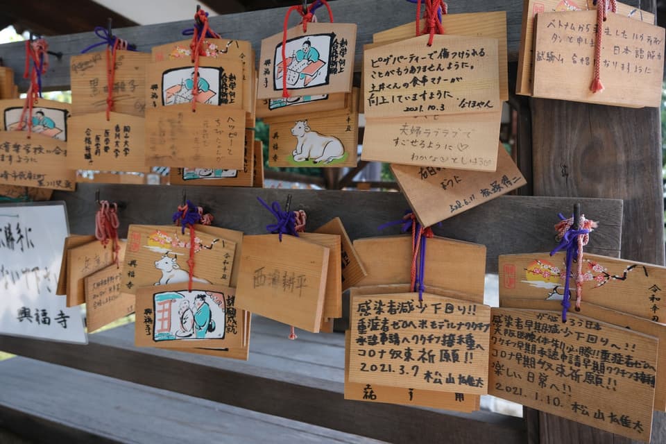 Hanging wooden ema boards with written wishes at Kasuga-taisha in Nara, Japan.