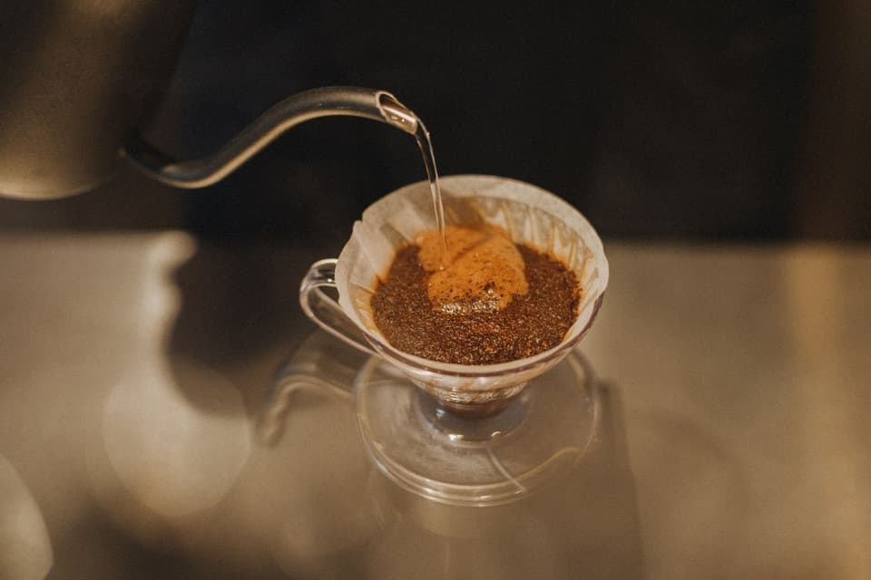 Experience the art of pour-over coffee in a Tokyo café, capturing the essence of hand-brewed perfection.