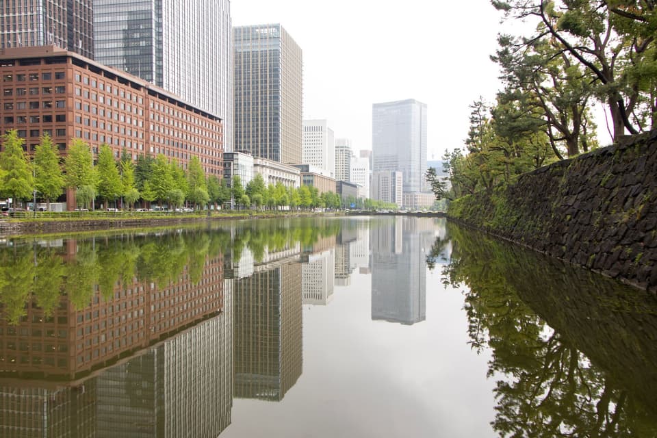 High-rise buildings along a tranquil waterway in Chiyoda, Tokyo, Japan.