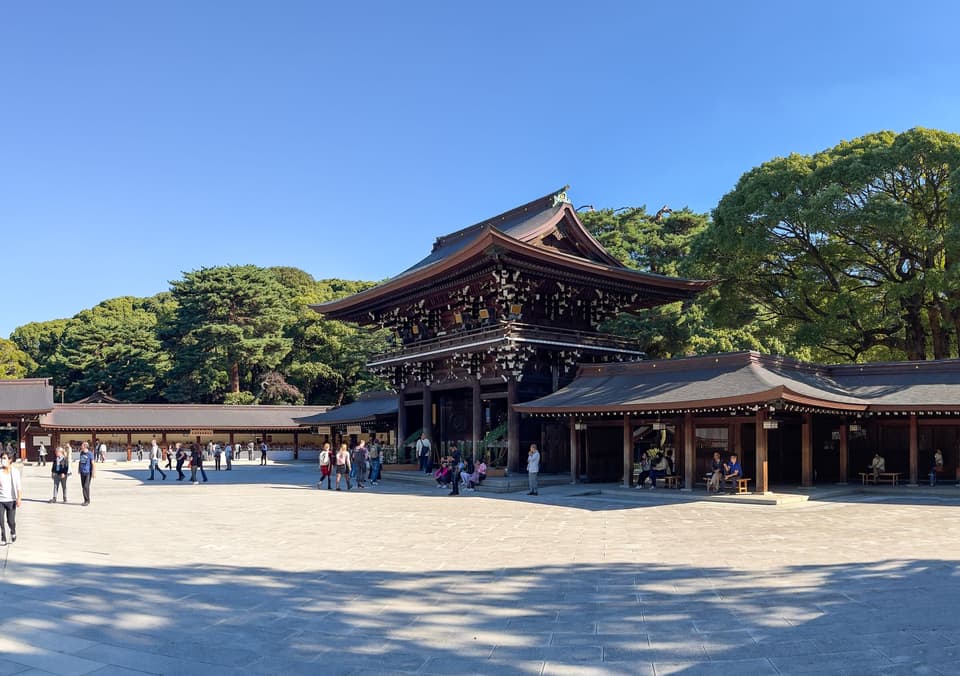 Scenic view of Meiji Shrine architecture amidst lush greenery in Tokyo, Japan.