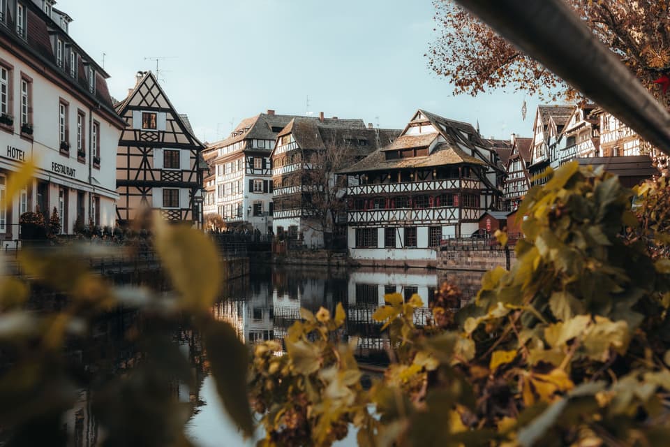 Charming half-timbered houses along the canal in Petite France, Strasbourg in autumn.