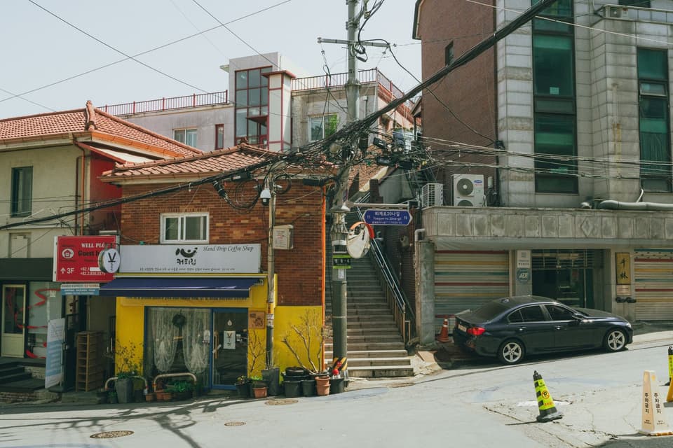 Cozy urban street view in Seoul, showcasing charming Korean architecture and vibrant city life.