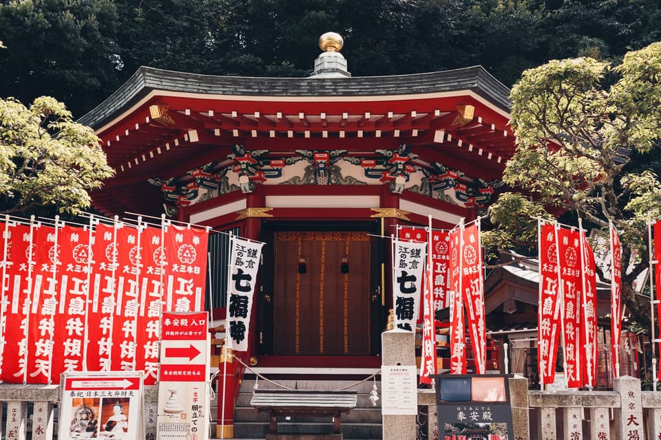 Explore a traditional Japanese shrine with vibrant banners in Tokyo.