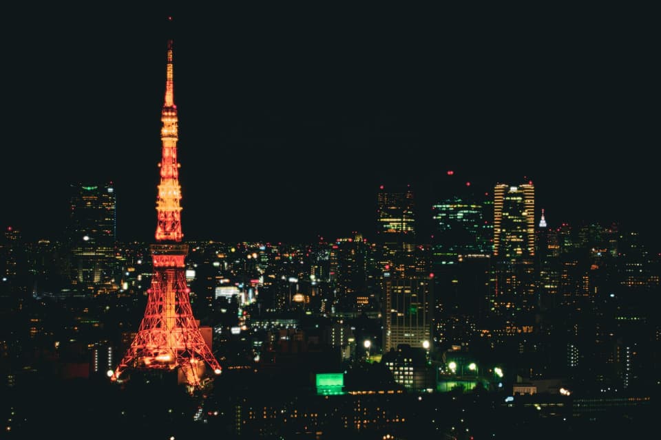 Night view of Tokyo's vibrant cityscape featuring the illuminated Tokyo Tower, symbolizing Japan's urban charm.