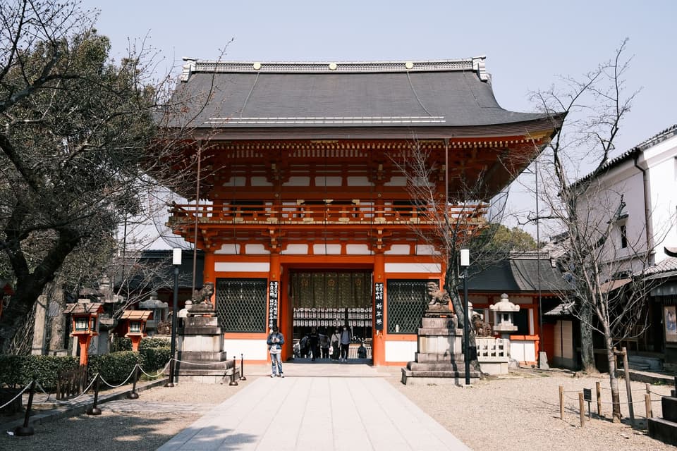 Captivating view of the historic Yasaka Shrine in Kyoto, showcasing traditional architecture under a clear blue sky.